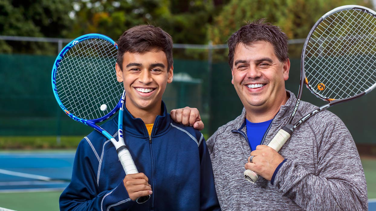 Father & son at tennis court